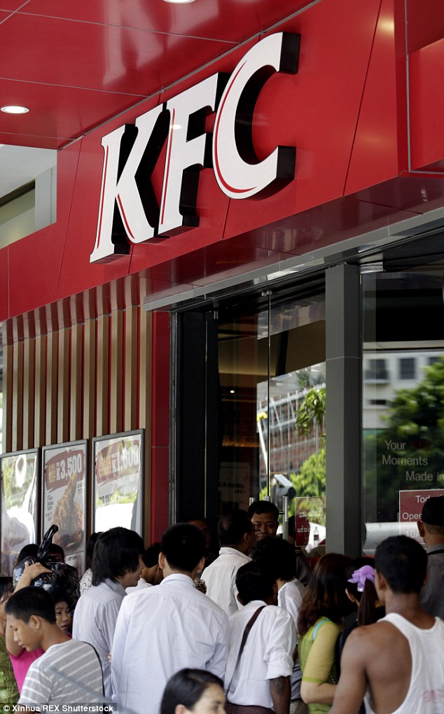 Worth the wait?: People line up to buy fried chicken outside a Kentucky Fried Chicken branch in Asia (stock image)